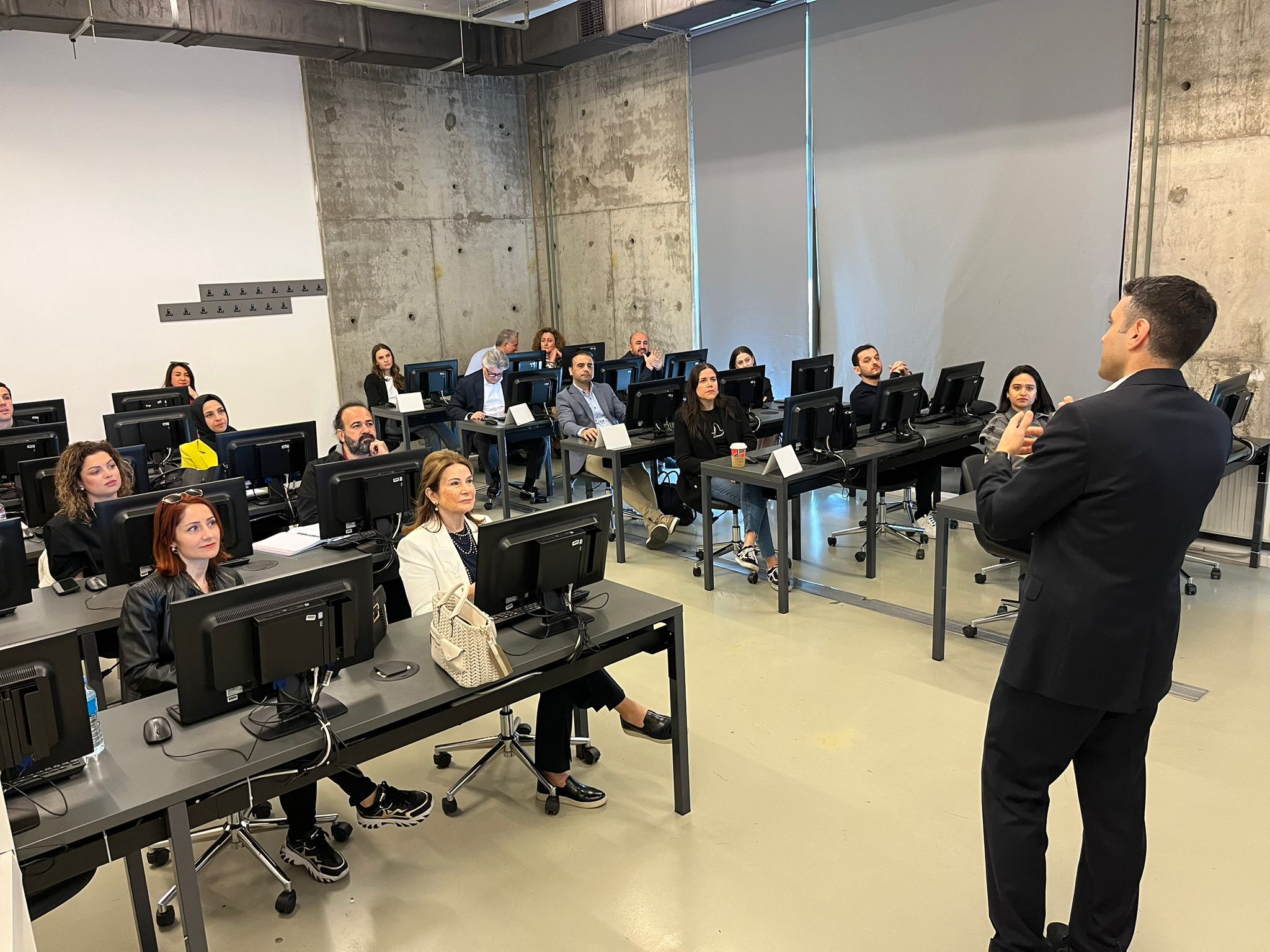 A speaker addressing participants during an in-person learning session
